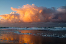 Storm Front Approaching Over The Sea After Sunset: Threatening Red Clouds Above The Dark Water