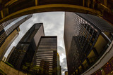 Fototapeta Miasta - Wide-angle view looking up through tall buildings and skyscrapers in downtown Chicago Illinois