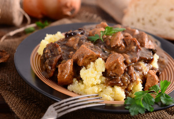 Wall Mural - Stew with meat, mushrooms and vegetables served with groat