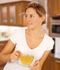 Wall Mural - WOMAN IN KITCHEN DRINKING HERBAL TEA