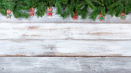 Wall Mural - Christmas evergreen branches and cookies on white vintage wooden planks