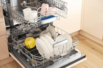 Poster - Open dishwasher with clean tableware in kitchen