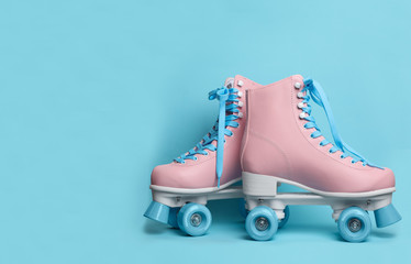 Wall Mural - pair of stylish quad roller skates on color background. space for text