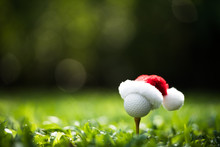 Festive-looking Golf Ball On Tee With Santa Claus' Hat On Top For Holiday Season On Golf Course Background