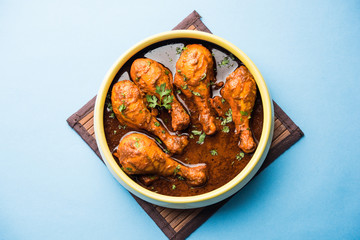 Chicken leg / drumstick curry or Murg Tangri/tangdi masala. Served in a bowl over moody background. Selective focus