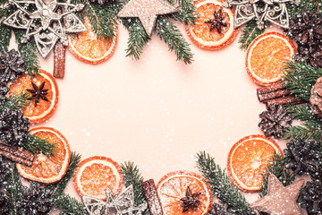 Wall Mural - Christmas natural frame of Dry Oranges Slices, fir cones and branches. Vintage toning and snow