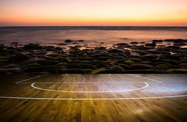 wooden floor basketball court with view sunset tropical beach