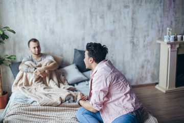 Wall Mural - Attractive gay couple at home, intimate moments of private life - Homosexual partners reconcile after quarrel.