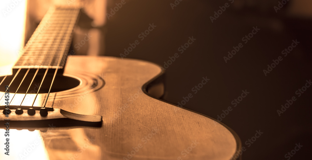 acoustic guitar close-up on a beautiful colored background - obrazy, fototapety, plakaty 