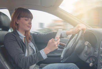 road safety concept. woman driving dangerously using smartphone.