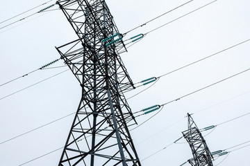 Two symmetrical metal electrical towers with wires