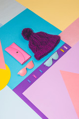 Wall Mural - Fashion set with pink purse, colorful sunglasses and purple knitted winter hat on memphis style background. Geometry concept