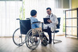© VIEWFOTO STUDIO - Doctor talking to senior women in wheelchair after check