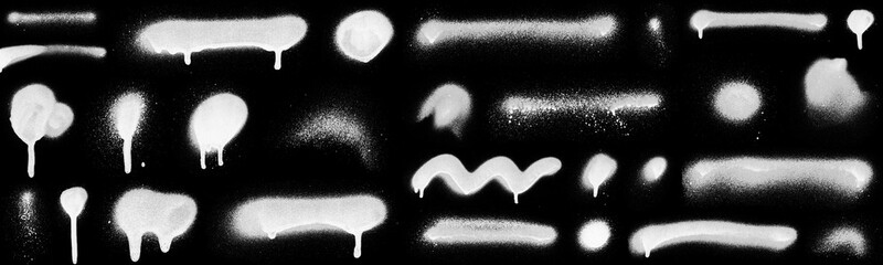 Realistic grunge graffiti spray paint effect on the black background. Isolated white ink texture.
