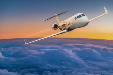 Private jet plane flying above dramatic clouds.