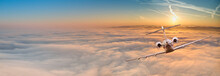 Private Jet Plane Flying Above Dramatic Clouds.