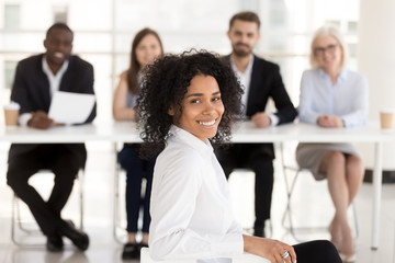 Wall Mural - Successful happy mixed race applicant with hr recruiting team portrait, smiling african american woman vacancy candidate or job interview winner looking at camera getting hired, employment concept