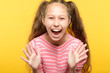 overexcited enthusiastic laughing girl. child portrait on yellow background. emotion and facial expression.