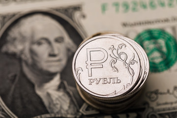 Few ruble coins on a dollar bill, closeup