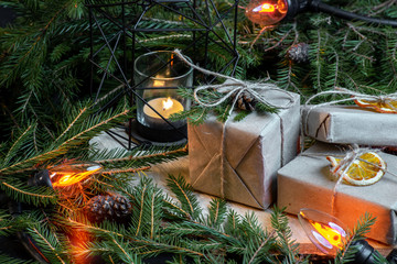 Christmas gift boxes with christmas tree branches and decoration and garland.