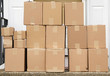 © nd700 - stacking delivered package boxes in front of the front door of house