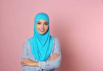 Wall Mural - Portrait of young Muslim woman in hijab against color background