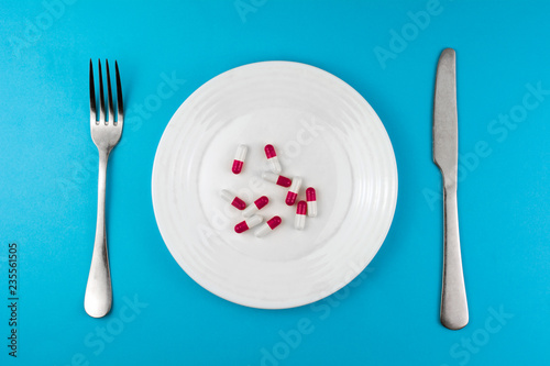 Pharmaceutical Medicine Pills Or Capsules On A Plate With A Fork