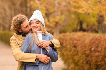 Sticker - Young romantic couple in park on autumn day