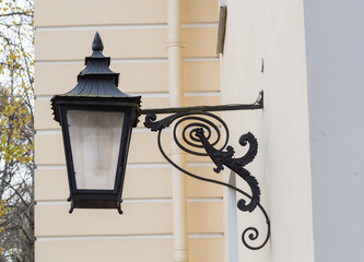 An ancient street lamp on the wall of the building