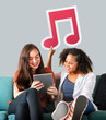 © Rawpixel.com - Young female friends holding a musical note icon