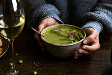 Woman Holding A Bowl Of Green Pea Soup