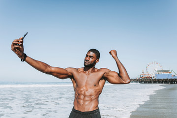 Wall Mural - Fit man taking a selfie by Santa Monica Pier