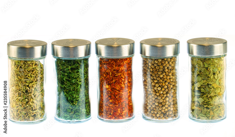 collection of spice and herbs seasoning in glasses bottles isolated on white background - obrazy, fototapety, plakaty 