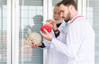 © gballgiggs - Doctor man working and using skull with plastic brain model together at hospital