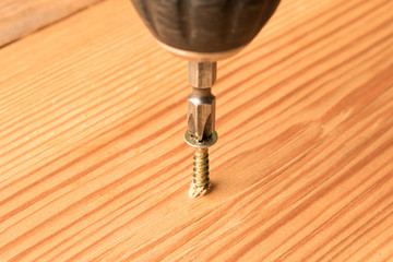 Screwdrivers and screws on a wooden table. The concept of work. Labor day