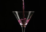 Fototapeta  - pink cocktail poured into a glass on a dark background.