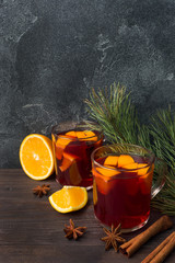 Wall Mural - Christmas mulled red wine with spices and fruits on a wooden rustic table. Traditional hot drink at Christmas time
