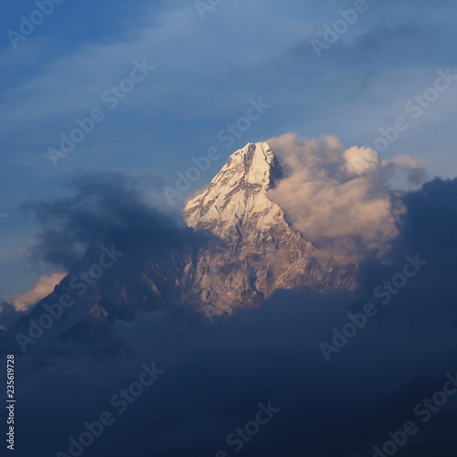 фотография Peak of Mount Ama Dablam reaching out of clouds, Nepal.