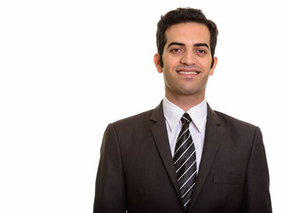 Portrait of young happy Persian businessman smiling