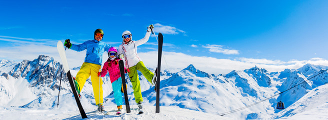 Fototapete - Happy family enjoying winter vacations in mountains, Val Thorens, 3 Valleys, France. Playing with snow and sun in high mountains. Winter holidays.