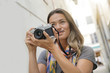 © goodluz - Young woman taking photos as a tourist