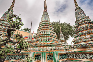 Amazing view through the trees at Wat Pho. Temple of the Reclining Buddha in Bangkok, Thailand.