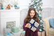 © be free - waiting for santa. Winter. Cute little child girl with xmas present. happy new year. Christmas shopping. christmas family holiday. The morning before Xmas. Wishing a happy New Year