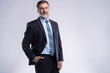© opolja - Happy satisfied mature businessman looking at camera isolated on white background.