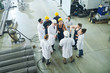 © Seventyfour - Portrait of multi-ethnic group of workers standing round senior engineer giving instructions on project in plant workshop, copy space