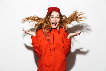 Wall Mural - Portrait of an excited girl wearing hoodie jumping