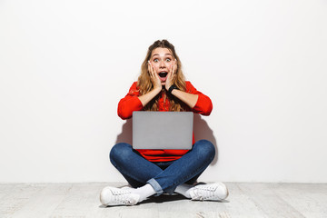 Wall Mural - Portrait of an excited young woman wearing hoodie