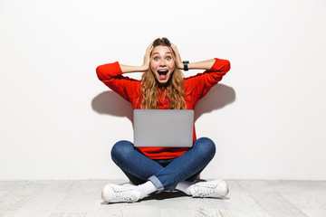 Sticker - Portrait of an excited young woman wearing hoodie