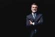 © opolja - Handsome mature business man isolated on black background