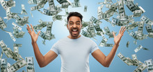 Success, Wealth And Finances Concept - Happy Young Indian Man Celebrating Triumph Over Blue And Cash Money Falling Background